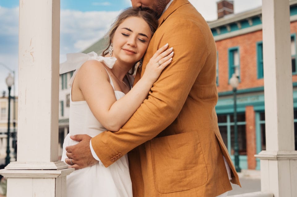Cuplu în îmbrățișare romantică pe verandă, ședință foto logodnă în aer liber